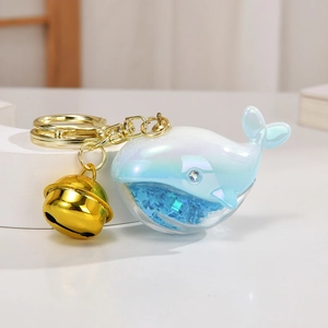 Creative laser acrylic whale keychain with blue glitter quicksand and gold bell pendant