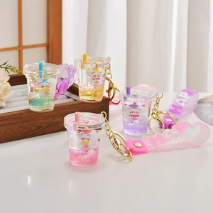 Close-up of assorted milk tea cup liquid quicksand keychains with colorful glitters