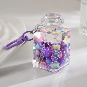 Creative liquid quicksand bottle keychain with colorful beads and purple spring clip