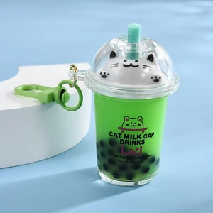 Detail of green cat milk tea cup keychain with white cat figurine and plastic hook