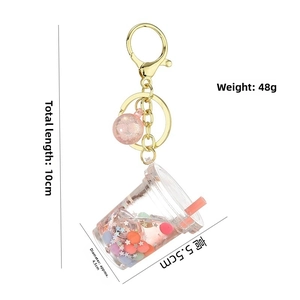 Luminous milk tea cup keychain with pink liquid and dimensions labeled on white background
