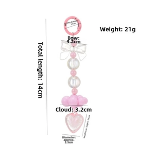 Detailed view of beaded keychain with pink heart, white bow and acrylic clouds with dimensions