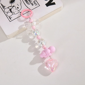 Pink heart acrylic keychain with bow and beads for bag charm accessory on white background
