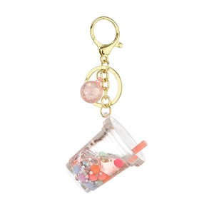 Creative glowing milk tea cup keychain with pink liquid, glitter, and golden lobster clasp