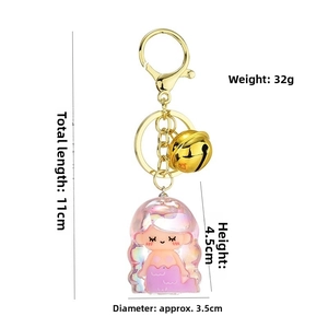 Detail of pink mermaid keychain with dimensions 11cm length and gold bell attachment