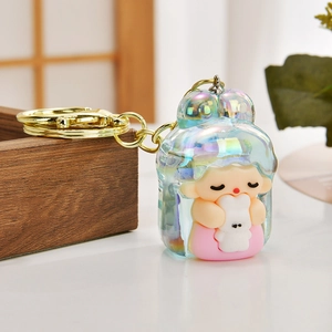 Close-up of cute cartoon character keychain with iridescent shell and gold keyring