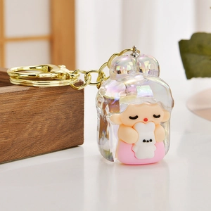 Detail of creative cartoon girl keychain with iridescent finish and gold metal ring