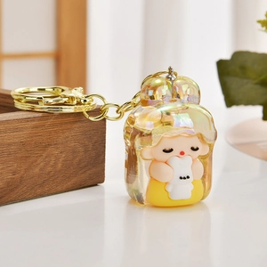 Iridescent cartoon girl with rabbit figurine keychain featuring golden metal hardware detail