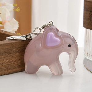 Close-up of translucent purple elephant keychain with acrylic texture and silver ring
