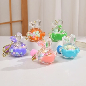 Set of 5 colorful liquid unicorn glitter keychains with gold rings on display