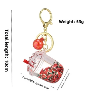 Detail view of unicorn cup keychain showing 10cm length, weight and components