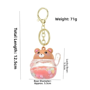 Detail showing dimensions of bear liquid quicksand keychain with red fluid and foam beads