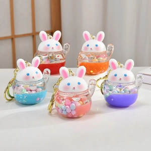 Detail of colorful liquid unicorn keychains with acrylic beads and golden metal rings