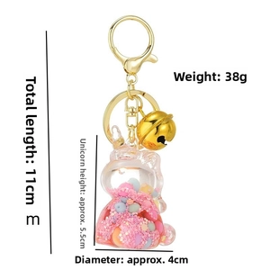 Detailed view of unicorn liquid glitter keychain with gold bell and dimension markers