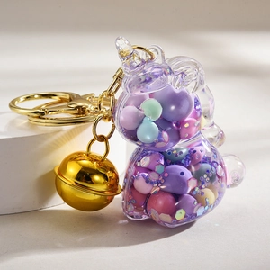 Unicorn keychain with colorful liquid sand beads, golden bell, and acrylic pendant charm