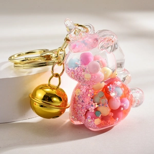 Unicorn liquid sand keychain with colorful beads, golden bell, and acrylic case