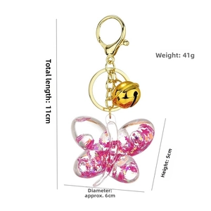 Detailed size view of acrylic butterfly keychain with pink glitter and gold clasp