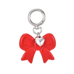 Red bow keychain with silver heart pendant on a metal spring ring for bag accessories
