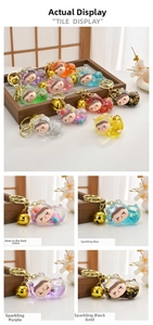 Detail view of translucent resin cat charms with glitter, sequins and golden bells