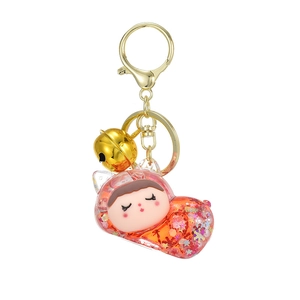 Cute sleeping girl liquid glitter keychain with golden clasp and bell accessory