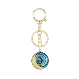 Golden owl evil eye keychain with artistic blue swirl pendant and lobster clasp