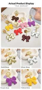 Macro detail of acrylic bow keychains with gold heart tags in various vibrant colors