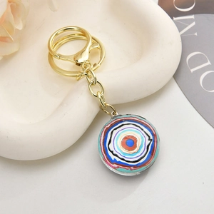 Retro evil eye owl keychain with a colorful round pendant on a gold metallic ring