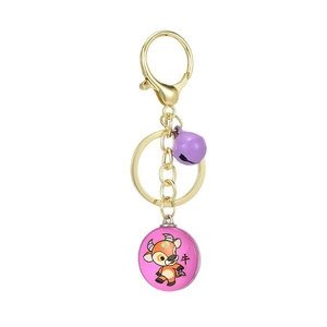 3D golden metal keychain with cartoon ox pendant and purple bell on white background