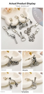 Close-up of vintage silver punk keychains featuring skull bicycle and guitar shapes