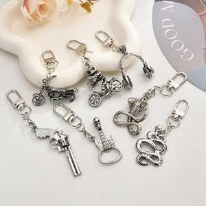 Vintage silver punk keychains set featuring skull, motorcycle, and pistol charms