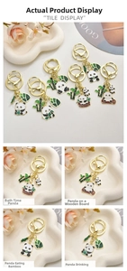 Detail of four cute enamel panda keychains with bamboo charms in various playful poses