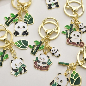 Detailed close-up of alloy panda keychains with green bamboo and enamel charms