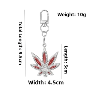 Detailed view of silver cannabis leaf pendant with rhinestones and dimensions 9.5cm