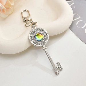 Sparkling silver key pendant with micro-pave crystals and iridescent gemstone
