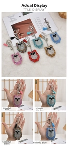 Detail view of colorful owl keychains with rhinestones, tassels, and bells on soft fur