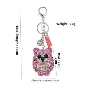Detail view of sparkling pink owl keychain with tassel and dimensions of 16cm total length