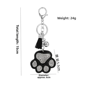 Detailed view of rhinestone bear paw keychain with measurements and tassel accessory