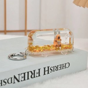 Detail of creative bus liquid quicksand keychain with stars and cartoon animal inside