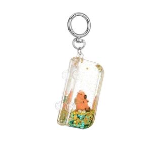 Cute Capybara liquid sand keychain with orange doll and gold stars in blue oil bottle