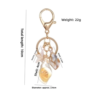 Detailed beach-themed keychain showing seashell and starfish charms with dimension labels