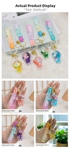 Close-up of liquid quicksand astronaut keychain with colorful beads and silicone strap