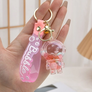 Pink astronaut liquid keychain with floating glitter and silicone wrist strap handle