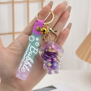 Purple astronaut keychain with liquid quicksand, golden bell and blue gradient wrist strap