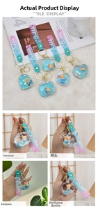 Close-up of bear and perfume bottle shaped liquid keychains with blue purple gradient glitter
