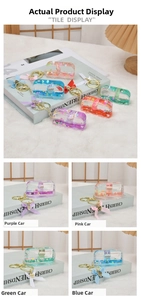 Detail of bus-shaped quicksand keychains with cartoon rabbits and liquid sequins