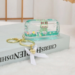 Mint green bus liquid sand keychain with Labubu figure and golden love heart charm
