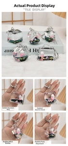 Detail view of cute rabbit acrylic keychains with floating glitter and liquid charms