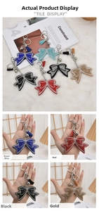 Detailed close-up of bowknot rhinestone keychains with tassels and bells in multiple colors