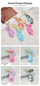 Detailed view of colorful seashell keychains in pink, blue, and purple options
