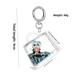 Detail of panda donut acrylic keychain with blue gold liquid glitter, 5x4x2.7cm size